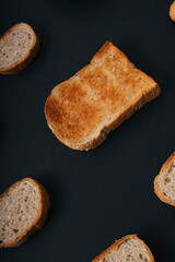Top view - Group of many type of bread over black background.