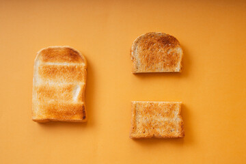 Top view - Grill sliced bread over orange background.