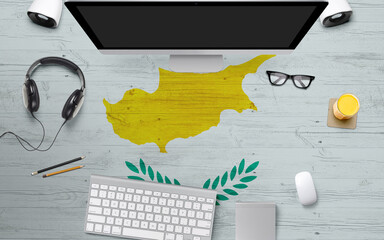 Cyprus flag background with headphone,computer keyboard and mouse on national office desk table.Top view with copy space.Flat Lay.