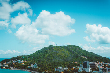 Fototapeta premium Panoramic coastal Vung Tau view from above, with waves, coastline, streets, coconut trees and Tao Phung mountain