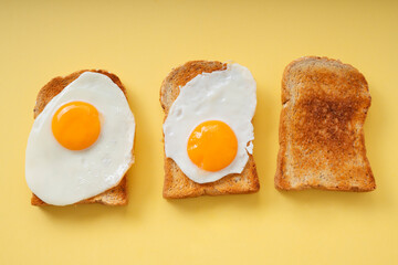 Three home made organic sliced bread grill with fried egg on top.