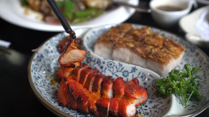 Chopsticks honey barbecue pork crispy Hong Kong Cantonese traditional cuisine