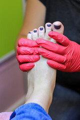 Female foot in process of professional pedicure in a beauty salon, close up. Beauty, health, fashion concept.
