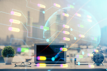 Double exposure of desktop with computer and world map hologram. International data network concept.