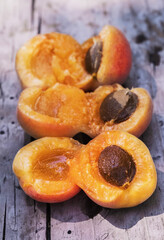 Juicy apricots with pits lie as a background