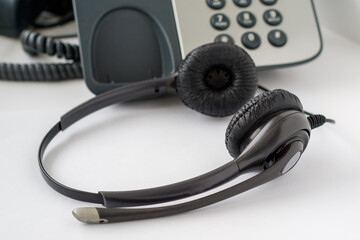 call center employee workplace, traditional push-button telephone and headset
