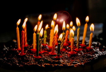 Colorful birthday cake with burning candles