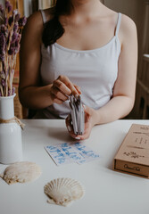 woman holding in her hands tarot cards
