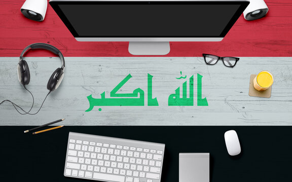 Iraq flag background with headphone,computer keyboard and mouse on national office desk table.Top view with copy space.Flat Lay. - Powered by Adobe