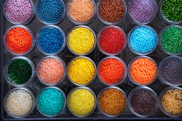 Beads in a box of different colors. Top view