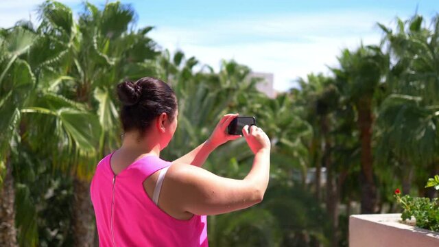 Woman taking picture on the vacations in 4k slow motion 60fps
