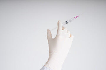 Doctor plastic gloves hand holding using syringe isolate over white background.