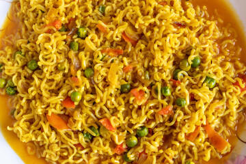 Spicy fried instant noodles with vegetable, close up top view