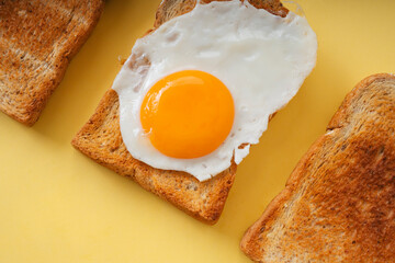 Three home made organic sliced bread grill with fried egg on top.