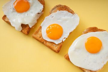 Three home made organic sliced bread grill with fried egg on top.
