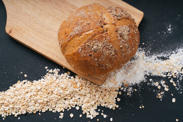 Top view - Whole wheat loaf bread on wooden pad.
