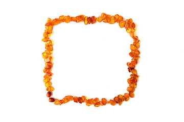 Necklace made of pieces of brown amber isolated on a white background. The view from the top. Copy space