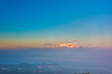 Naklejka na ściany i meble From Tiger Hill in Darjeeling to the Himalayan mountain range after sunrise the mountains are glowing and covered in clouds and fog, the colors of nature are beautiful divided into layers