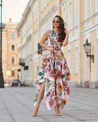 Young beautiful elegant tall slim woman with natural makeup and wavy brunete hair wearing colorful...