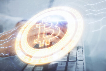 Crypto currency theme hologram with businessman working on computer on background. Concept of blockchain. Multi exposure.