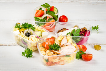 Several types of salads in plastic containers