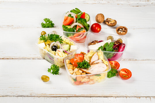 Several types of salads in plastic containers