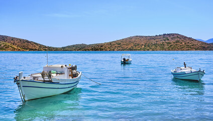 Fototapeta na wymiar View of lagoon with anchored fishermen's boats on a sunny summer day on Crete island, Greece
