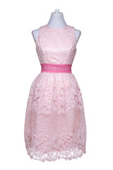 Lacy dress isolated. Closeup of a pink stylish sleeveless evening dress with lace on mannequin...