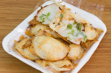 A kind of Thai sweetmeat (kanom krok), made from rice flour, coconut milk, and sugar; then grilled on the special holed stove.