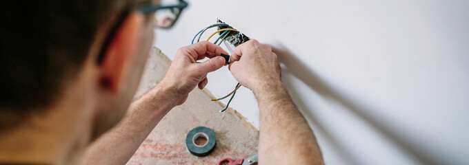 Electrician working on the electrical installation of a house