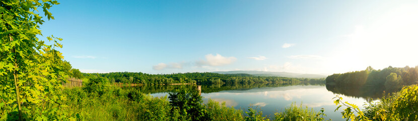 colorful panorama of autumn lake on a bright sunny day