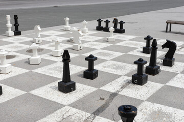 Outdoor large chess on the place. Chess pieces. Outdoor entertainment and games
