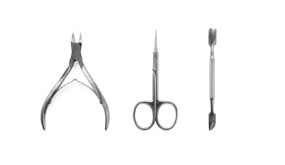 Fotobehang Manicure and pedicure nail care tools set isolated on white background, top view. Cuticle pusher, cuticle trimmer and purpose scissor © Olha Kozachenko