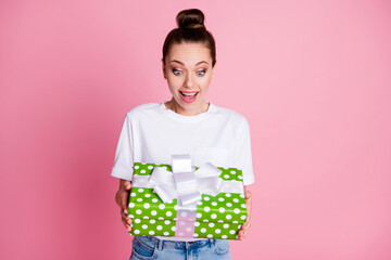 Photo of astonished crazy positive girl impressed big greed dotted gift box wear good look clothes isolated over pink color background