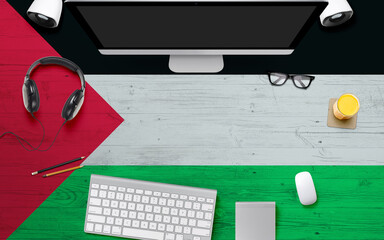 Palestine flag background with headphone,computer keyboard and mouse on national office desk...