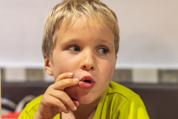 Close up portrait cute boy change his mood from smiling till serious, surprised, intriguing,...