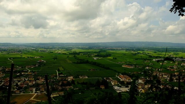 View of Piave area between Prealps and Montello hill with green Prosecco vineyards