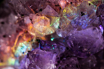Iridescent natural transparent glossy and magic geometric Quartz crystal stucture through sun light.