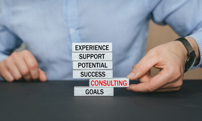 Businessman building wooden blocks with Consulting Technology Communication concept.