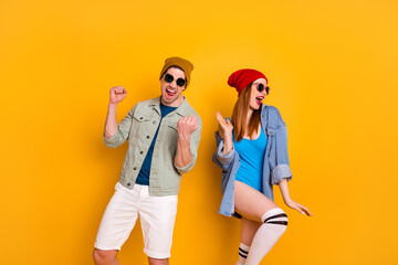 Portrait of his he her she nice attractive glad carefree cheerful cheery funny couple spending weekend dancing having fun leisure isolated on bright vivid shine vibrant yellow color background