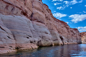 Fototapeta na wymiar View of narrow, cliff-lined canyon from a boat in Glen Canyon National Recreation Area, Lake Powell, Arizona