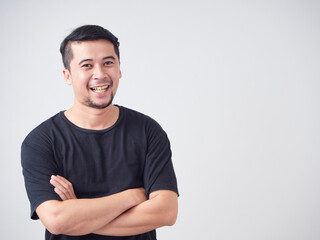 Young man crossed arms while standing.