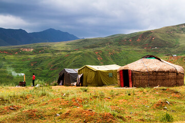 Yurts and tents in Tian Shan mountains near Pamir Highway in Kyrgyzstan, Central Asia