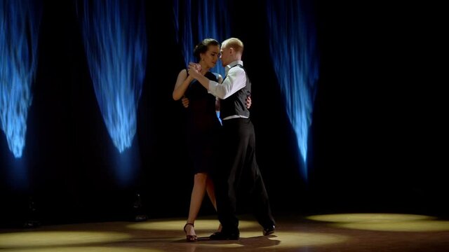 A man and a woman dancing tango. Beautiful light, professional dancers.