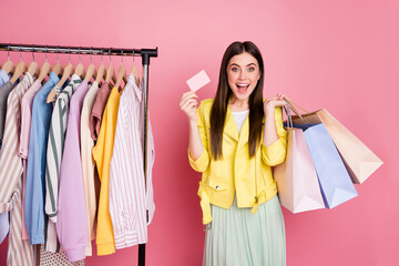 Photo of pretty lady showroom fashion collection choosing clothes hold many packs bonus card wear...