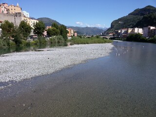 Fototapeta na wymiar Mountain calm river in the village of Ventimiglia Italy