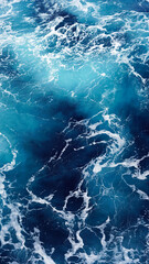 Background of the sea surface, foam stains on clean fresh ocean water. Vertical photo aerial view