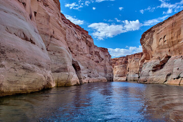 View of narrow, cliff-lined canyon from a boat in Glen Canyon National Recreation Area, Lake Powell, Arizona