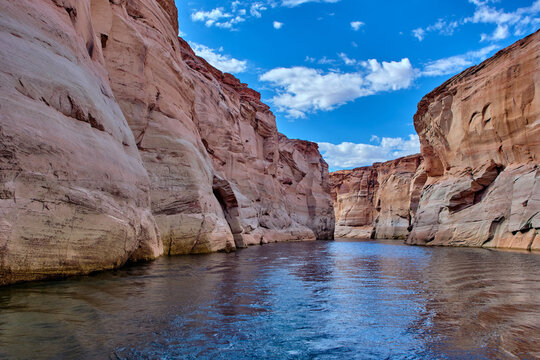 View of narrow, cliff-lined canyon from a boat in Glen Canyon National Recreation Area, Lake Powell, Arizona