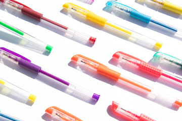 colorful gel pens pattern on a white background